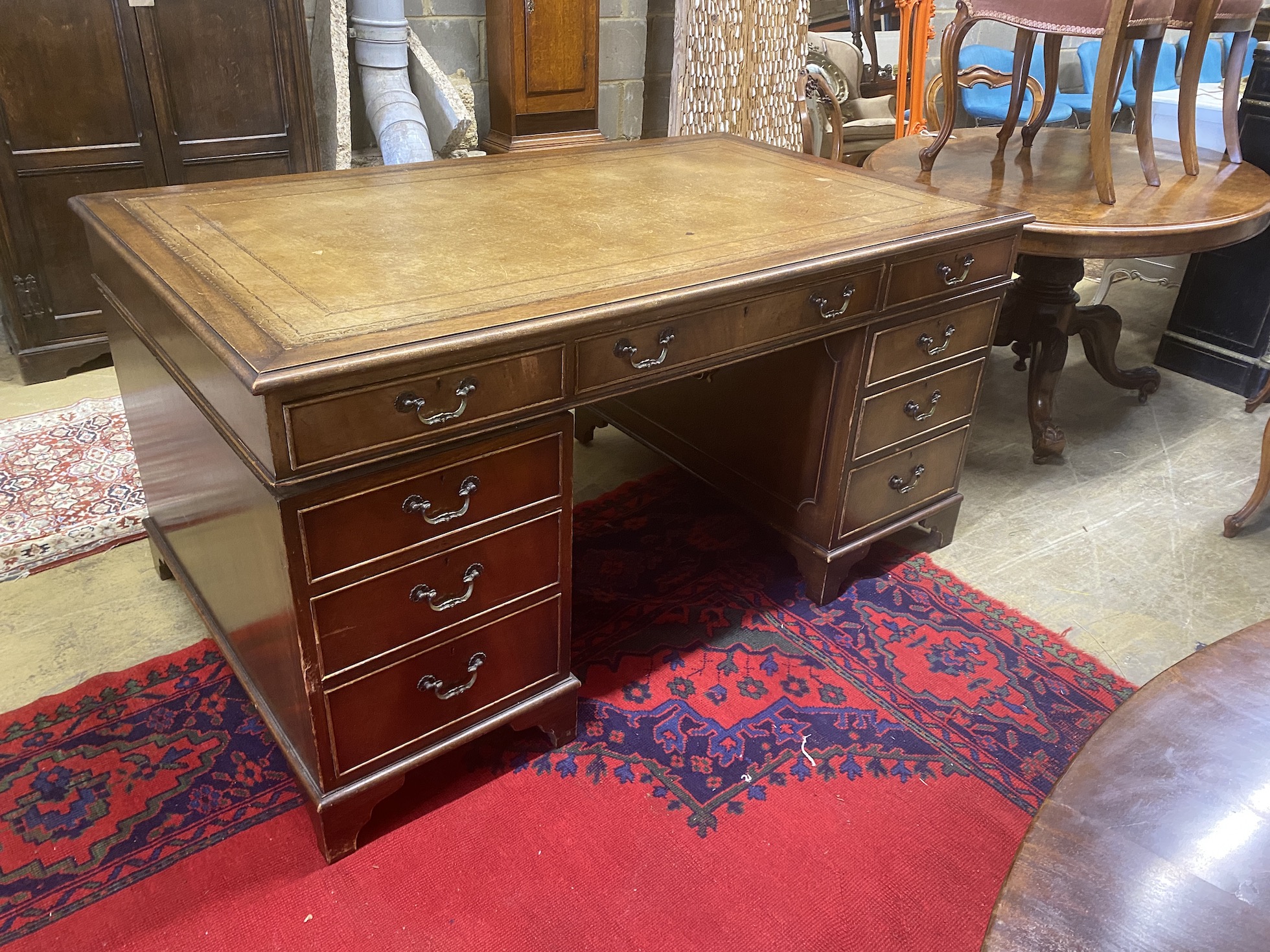 A reproduction George III style mahogany pedestal desk, length 154cm, depth 91cm, height 77cm